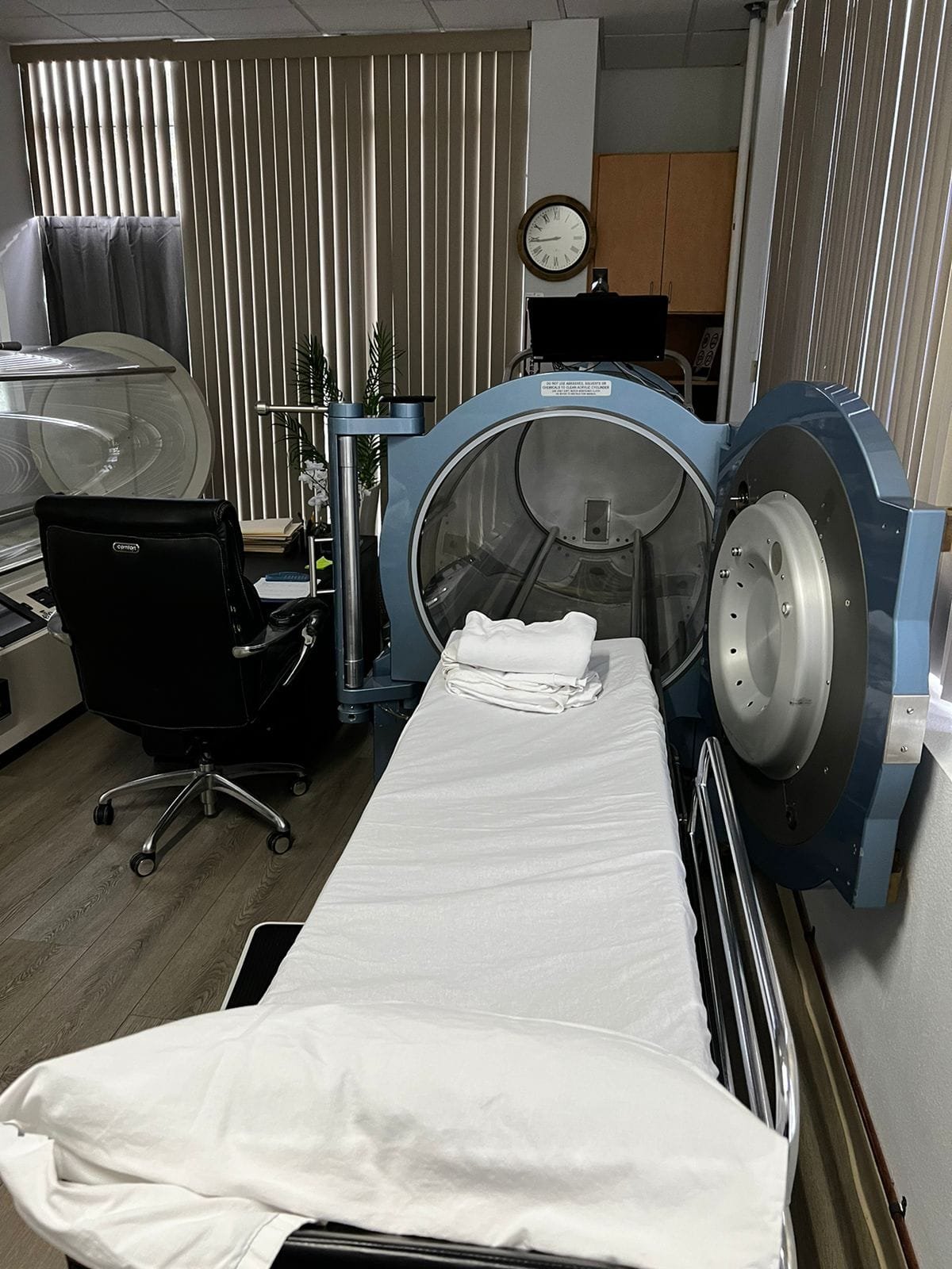 Open medical-grade hyperbaric chamber with patient bed at Pacific Hyperbarics — Monterey